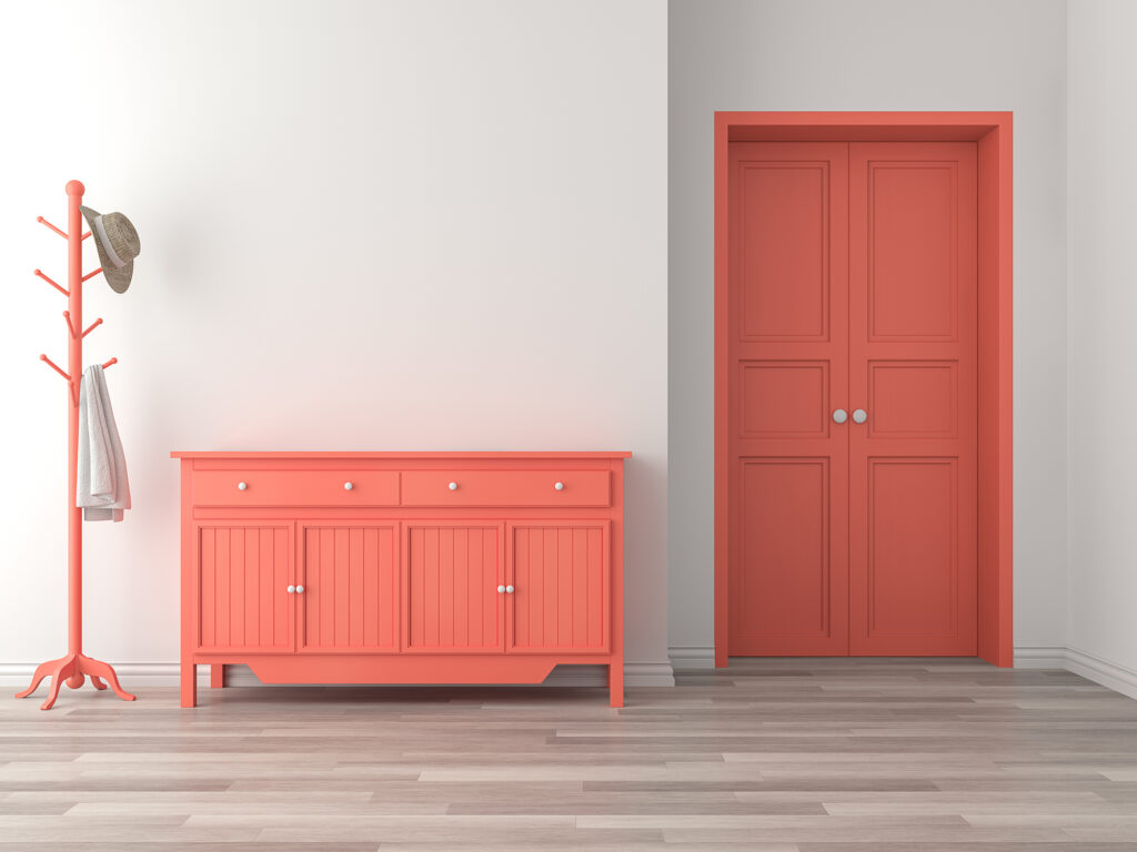 Laminate Flooring style in a small room with an orange dresser and door | Jordans Flooring