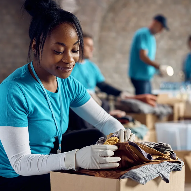 Woman volunteering at a community center going through donations | Jordans Flooring in Canada